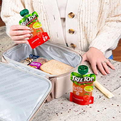 Packing Tree Top apple sauce pouches into a lunch box